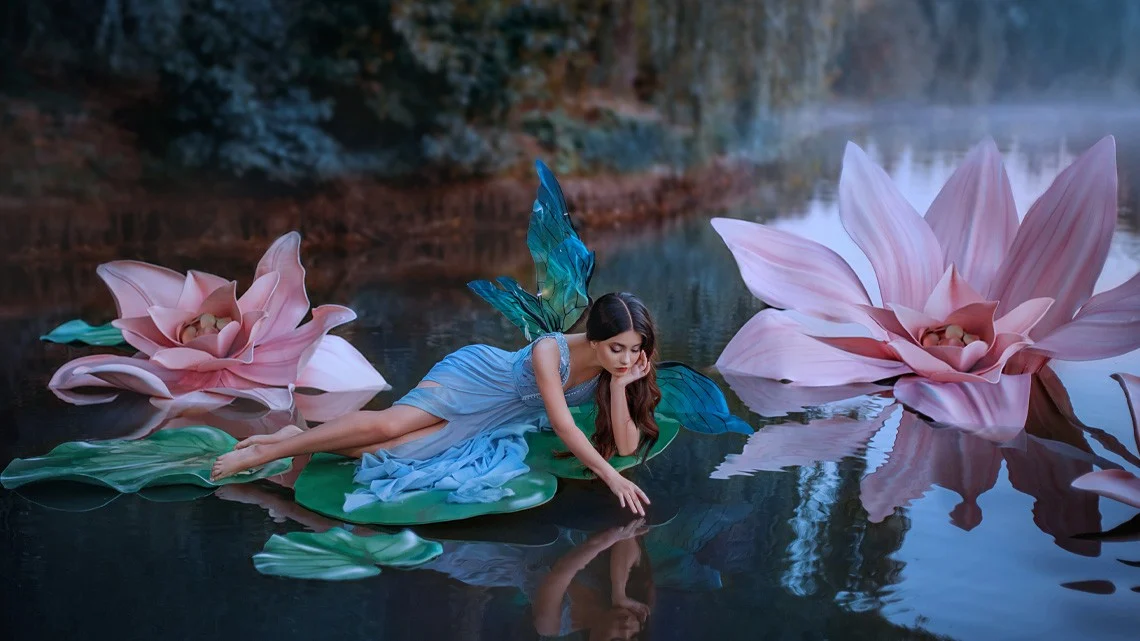 Fée allongée sur un nénuphar, touchant l'eau, entourée de fleurs géantes.